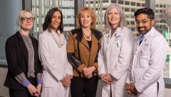 Rita Dragonette, center, poses with RUSH doctors