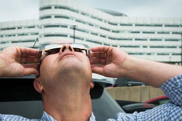 Man staring at eclipse with special glasses
