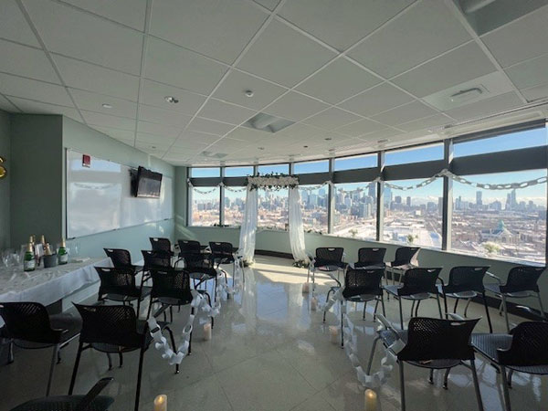 A conference room was transformed into a beautiful chapel with row seating and a makeshift altar at the front, backdropped by floor-to-ceiling windows overlooking the Chicago skyline.