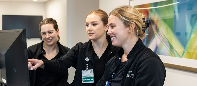 Three Rush nurses looking at a computer screen