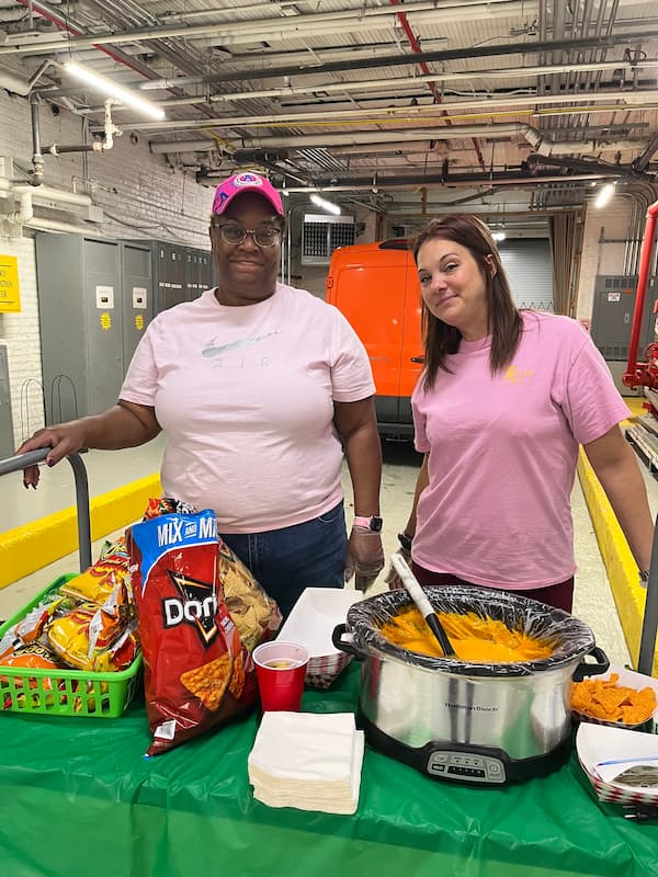 Barb and Tricia, Roscoe team members, participate in one of several “Pink Fridays," wearing pink attire while serving hot lunches .