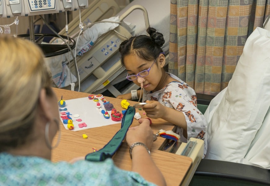 child patient working with nurse