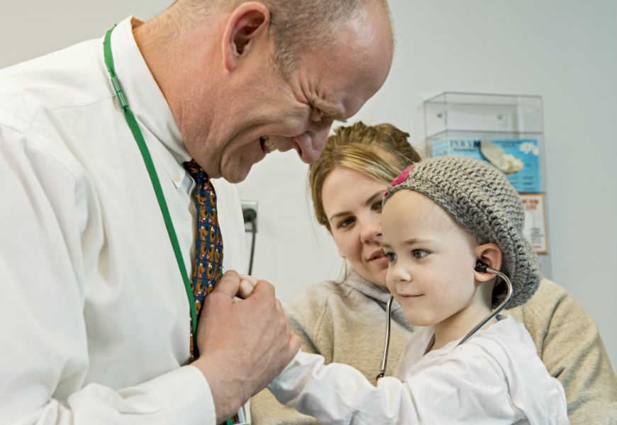 child patient listening to doctors heart