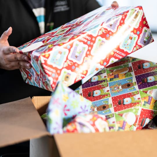 Adopt-a-Family volunteer delivering presents