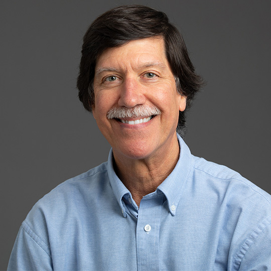 david bennett posed in front of a gray background