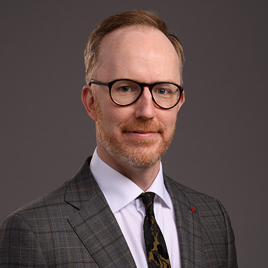 david reid posed in front of a gray background