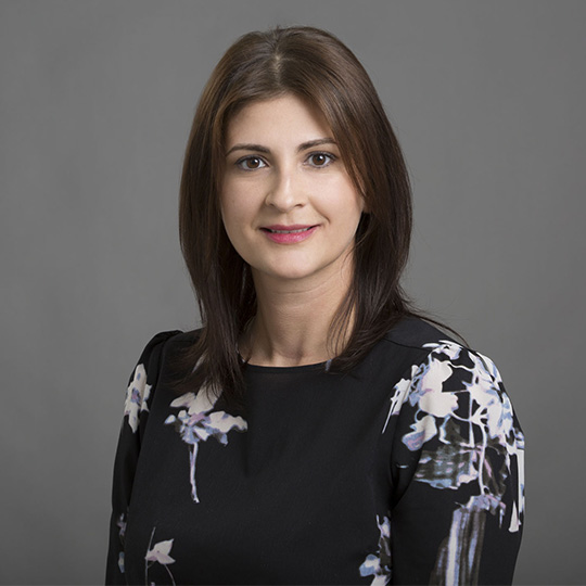 karolina marinescu posed in front of a gray background