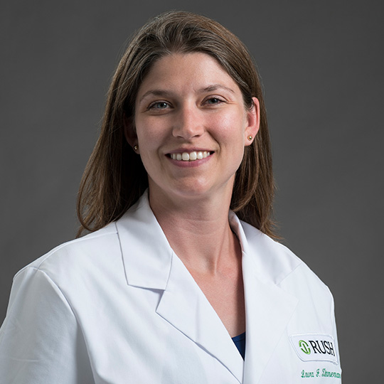 laura zimmermann in a white coat in front of a gray background