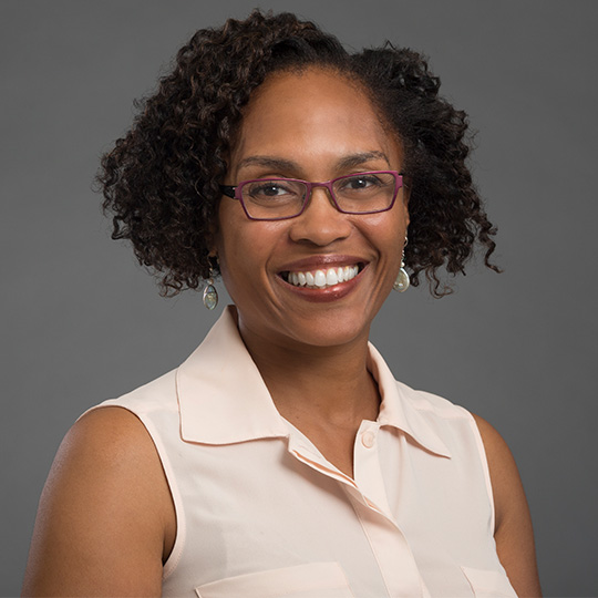 lisa barnes photographed in front of gray background