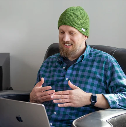 Man using a laptop for a telehealth appointment