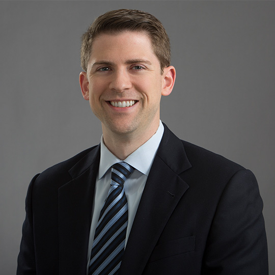 michael hanak posed in front of a gray background