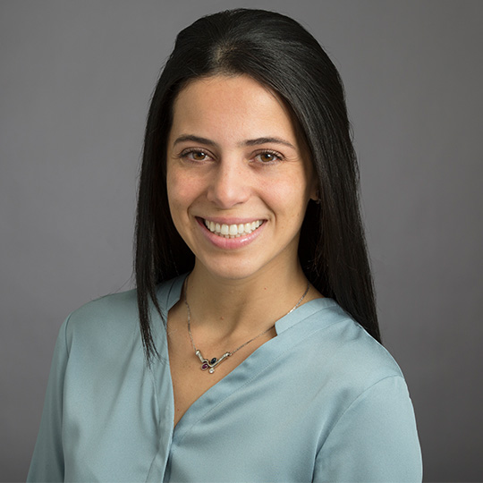 paola susan posed in front of gray background