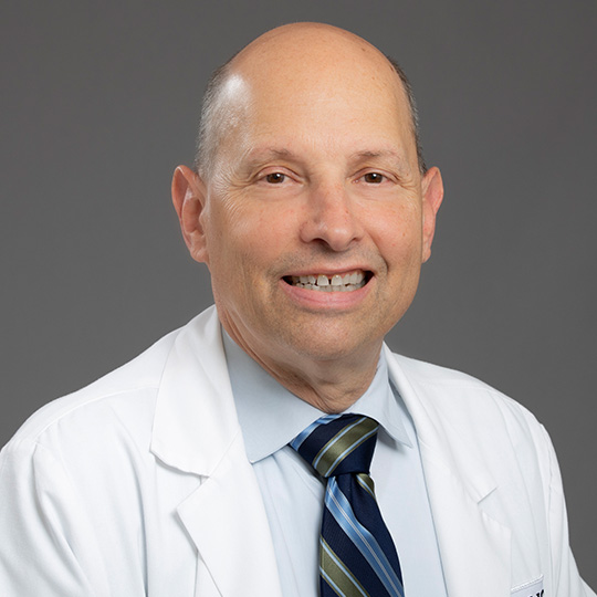 robert balk posed in front of a gray background