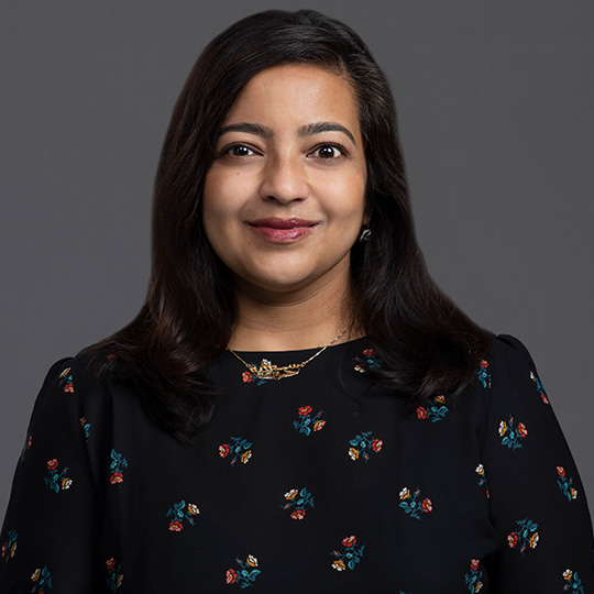 sadia haider posed in front of gray background