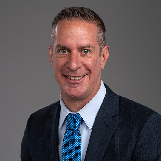 sean grimm posed in front of a gray background