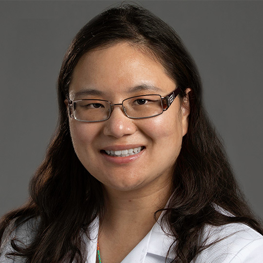 shannon li posed in front of gray background