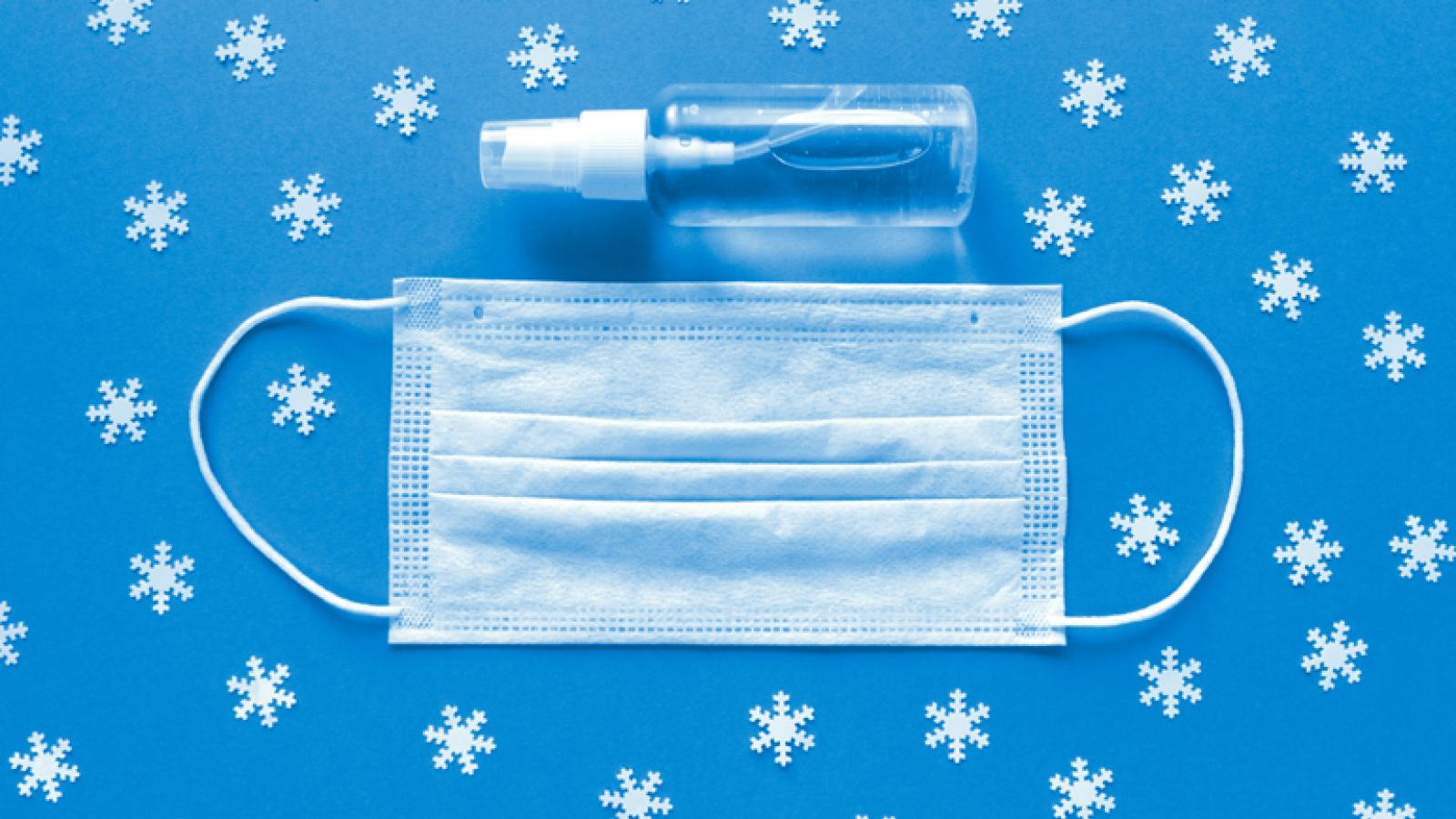 Face Mask and Hand Sanitizer Against Winter Backdrop