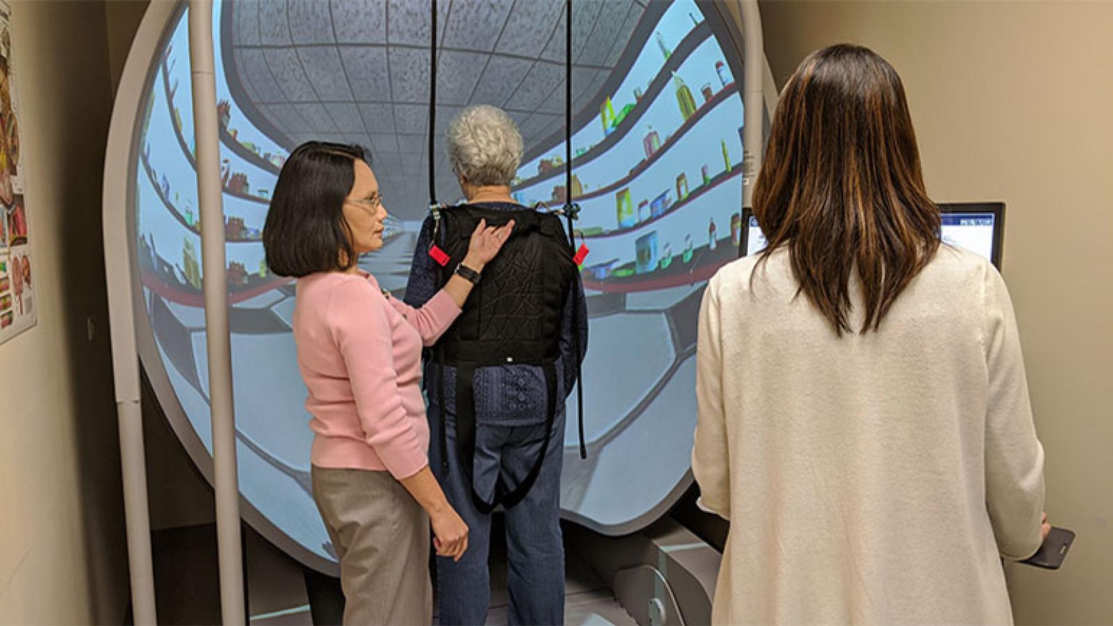 Patricia Worley works with Rush rehab therapists in the Bertec machine