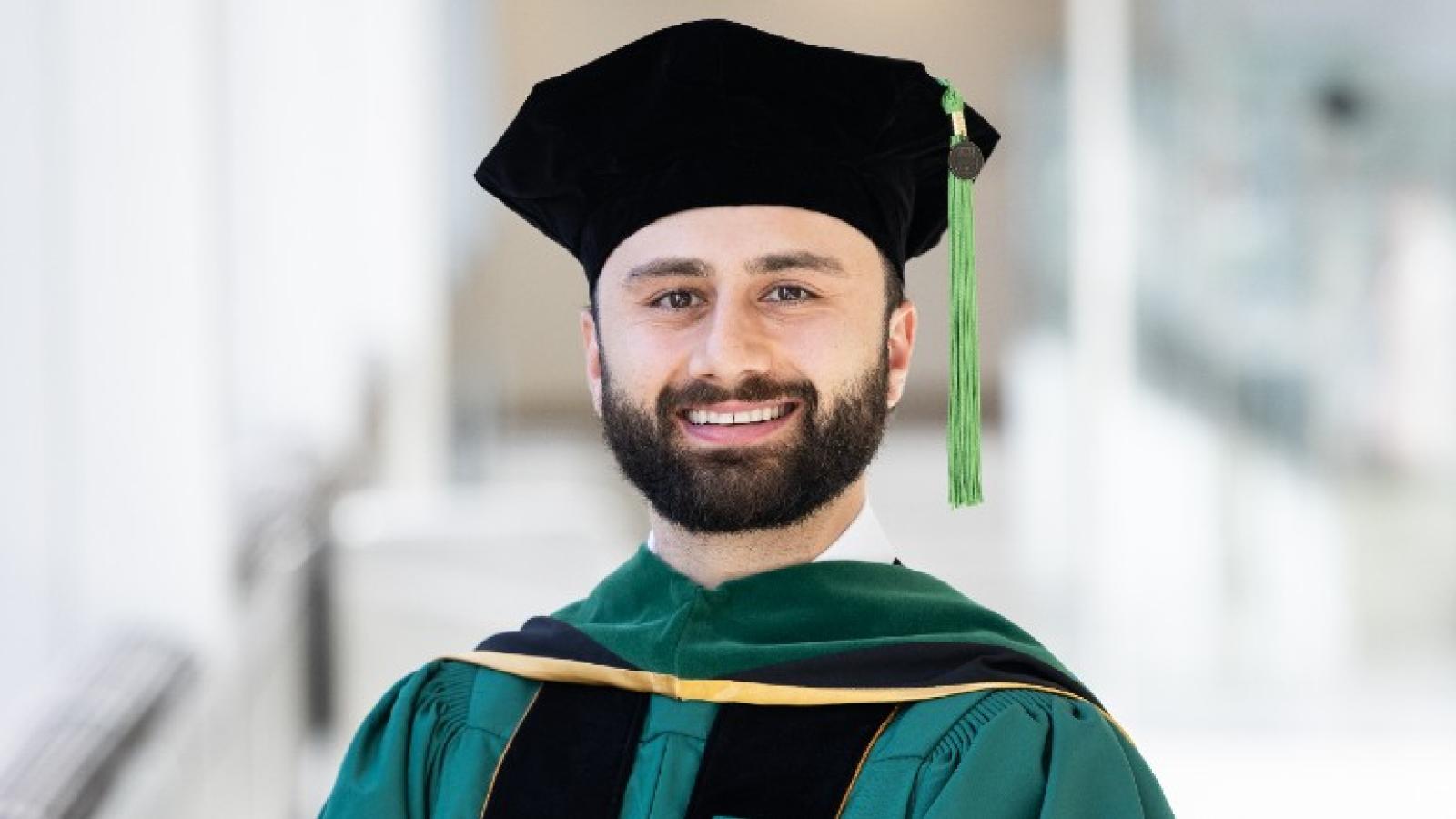 Andrew Mohama smiles in his regalia.