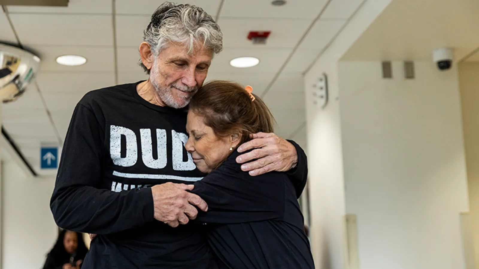 Two people hug at a hospital