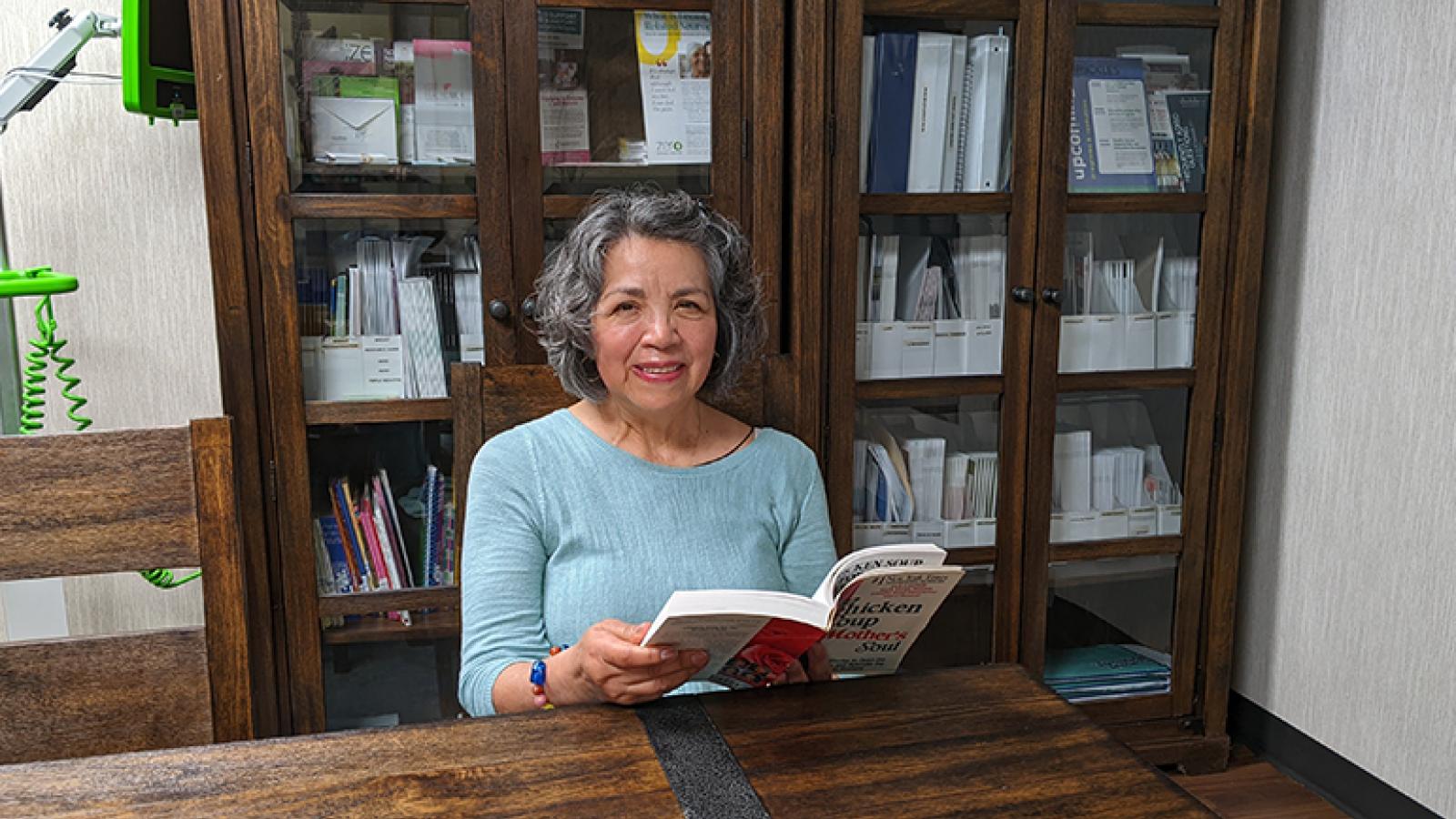 Angelica reads in the library at Waterford Place