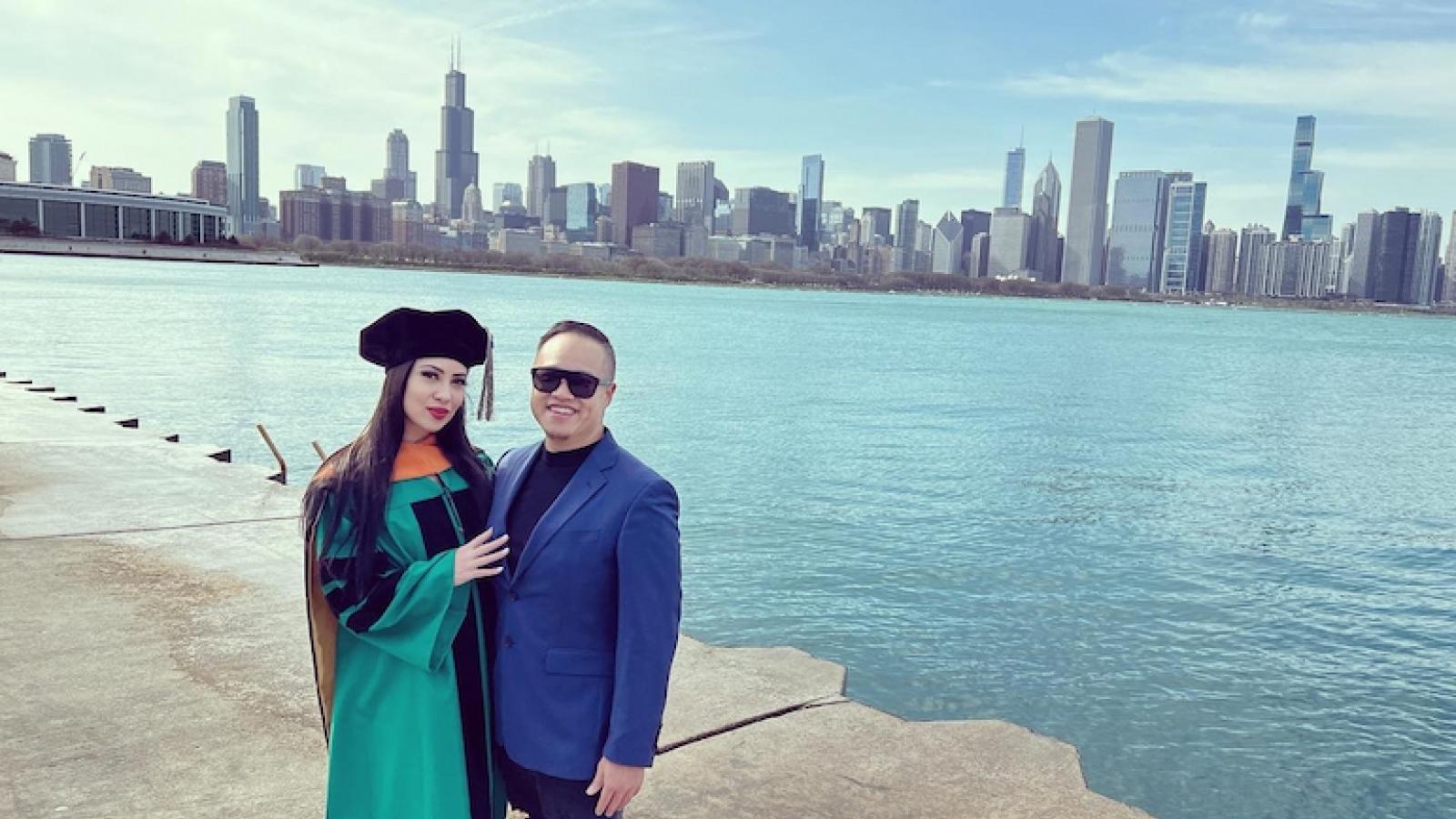 Frances Pastuszka and Kenny Lam stand along the Lake Michigan shore with the Chicago city skyline in the background.