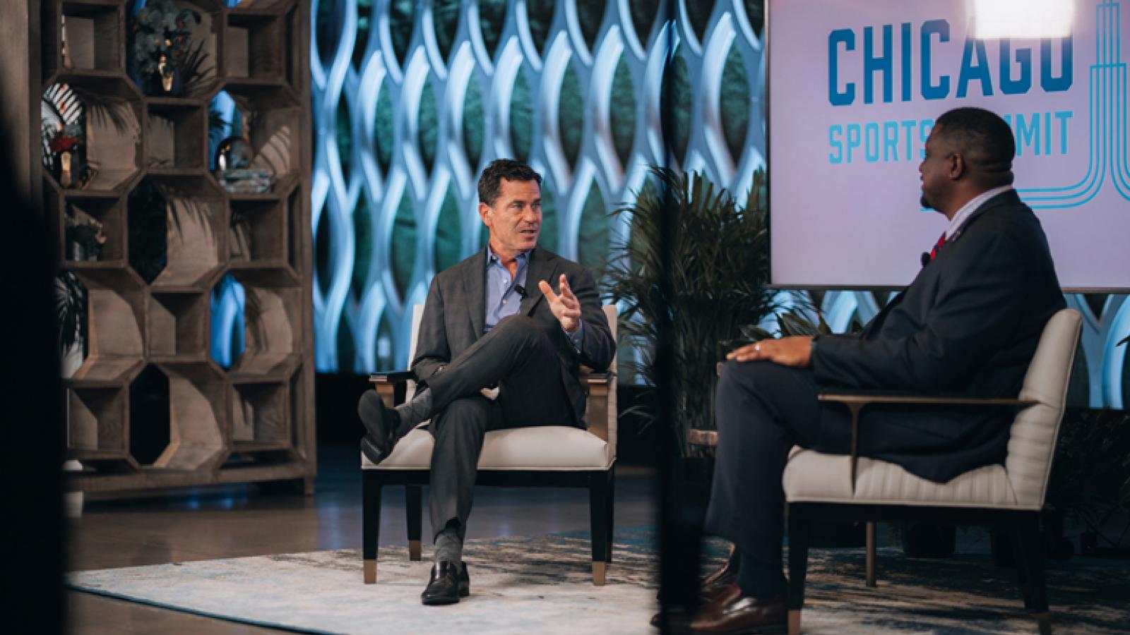 Two people have a discussion at the Chicago Sports Summit.