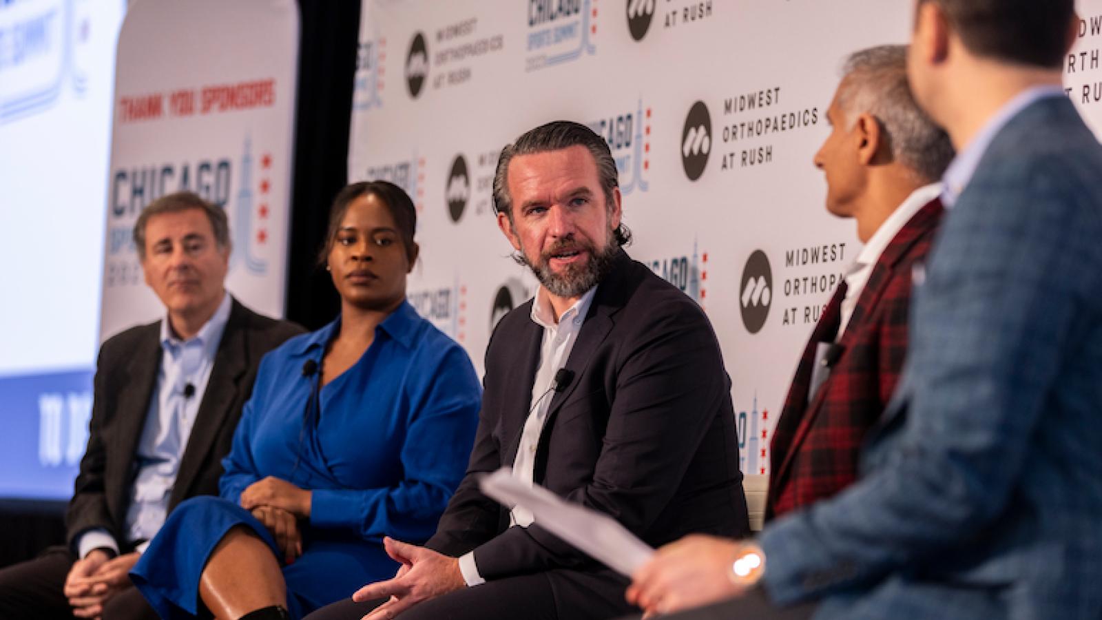 A group of panelists talk at the Chicago Sports Summit.