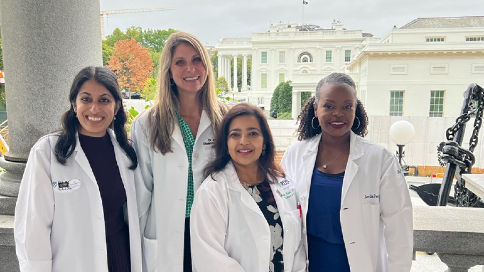 Sadia Haider, MD, MPH, smiling with colleagues at the White House