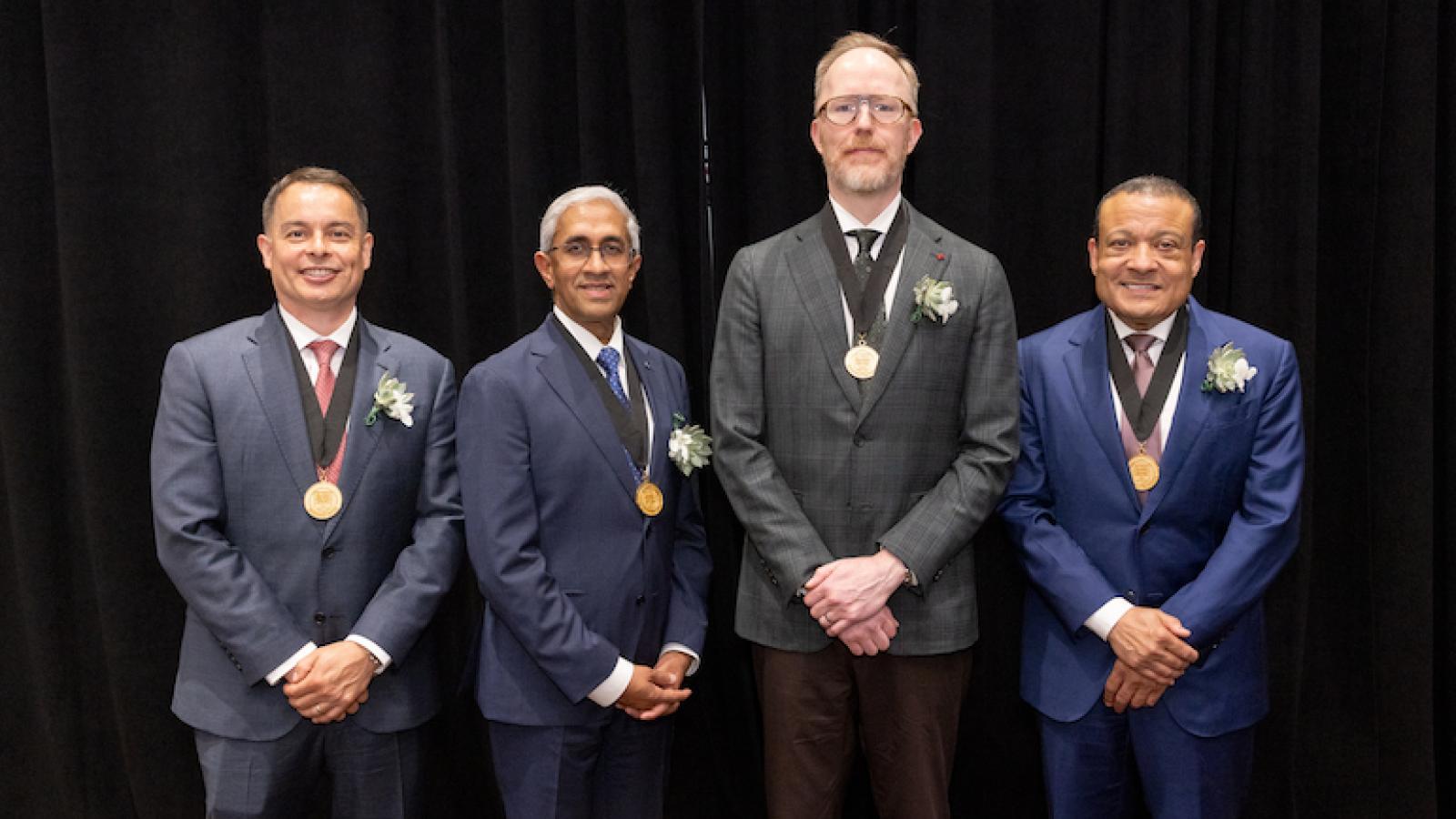 Standing left to right are Brian Forsythe, MD; Asokumar Buvanendran, MD; David C. Reid, MD, FAAD; and Lee Jones, MD. 