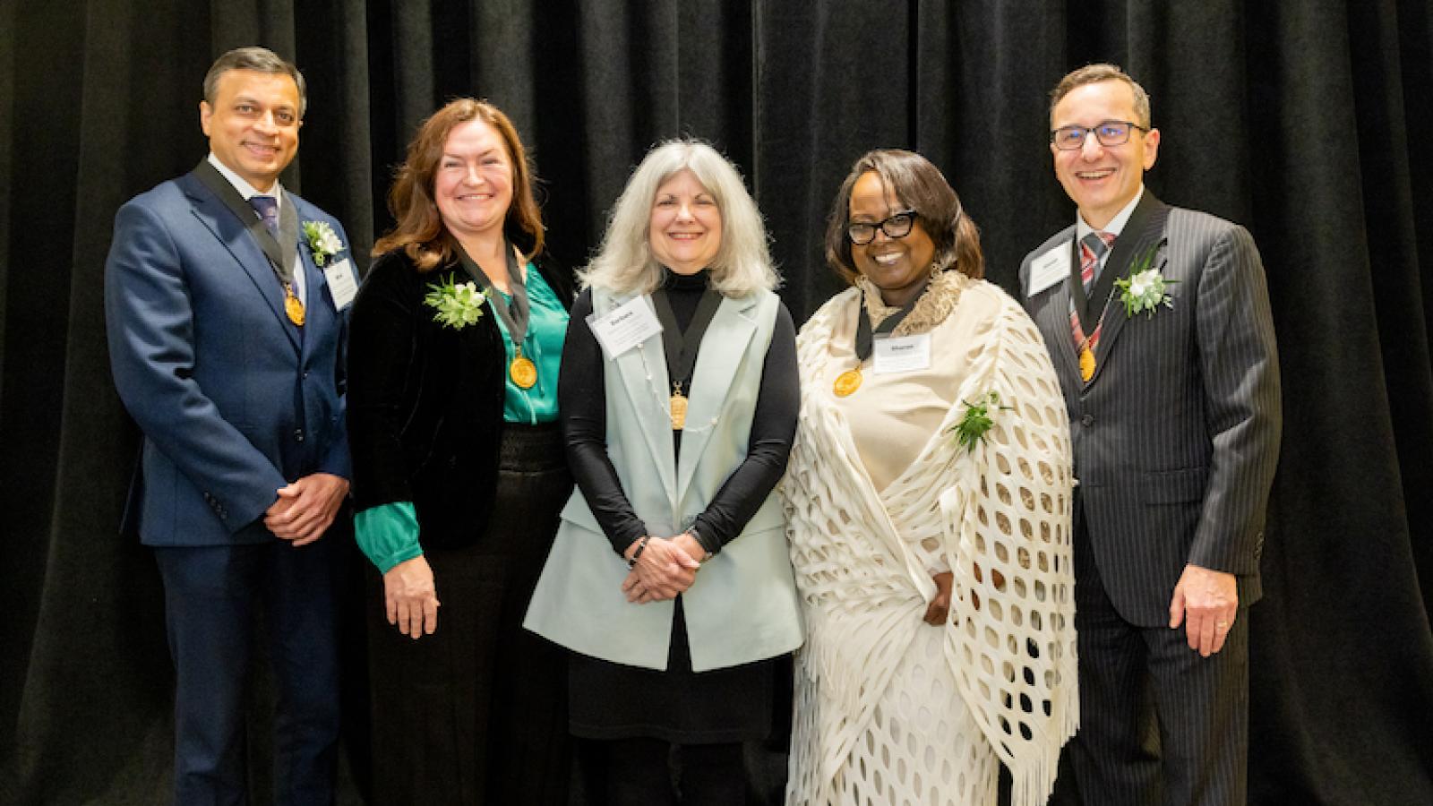 Pictured standing from left to right are Miral D. Jhaveri, MD, MBA; Angela M. Moss, PhD, APRN, FAAN; Barbara A. Swanson, PhD, RN, FAAN; Sharon D. Gates, DSW; and Steven K. Rothschild, MD.