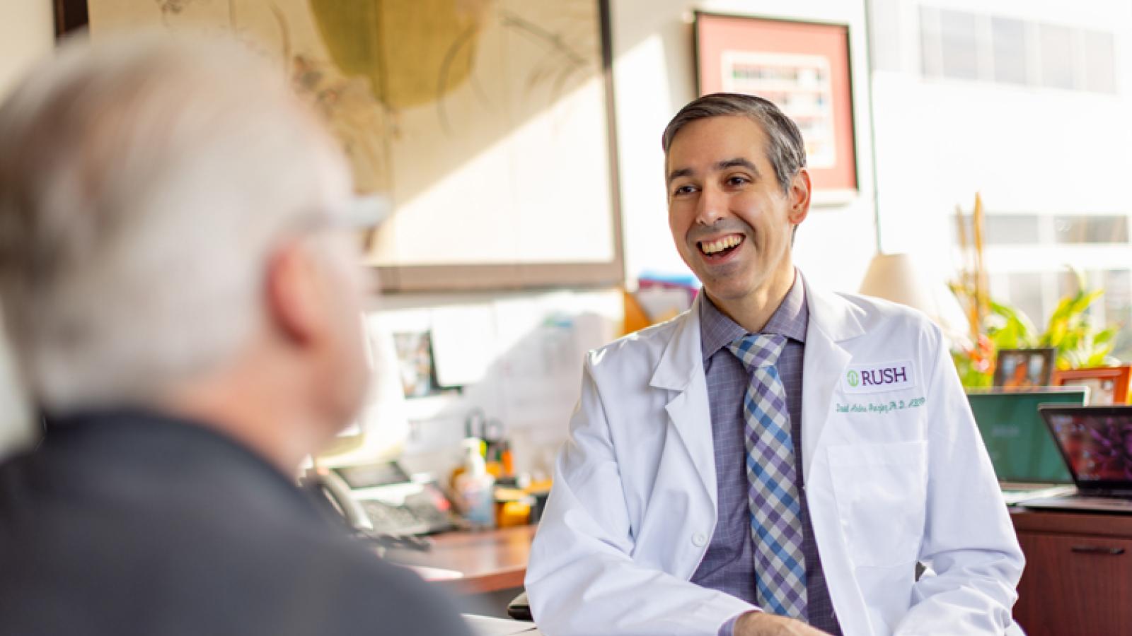 Dr. David Gonzalez speaks with a patient