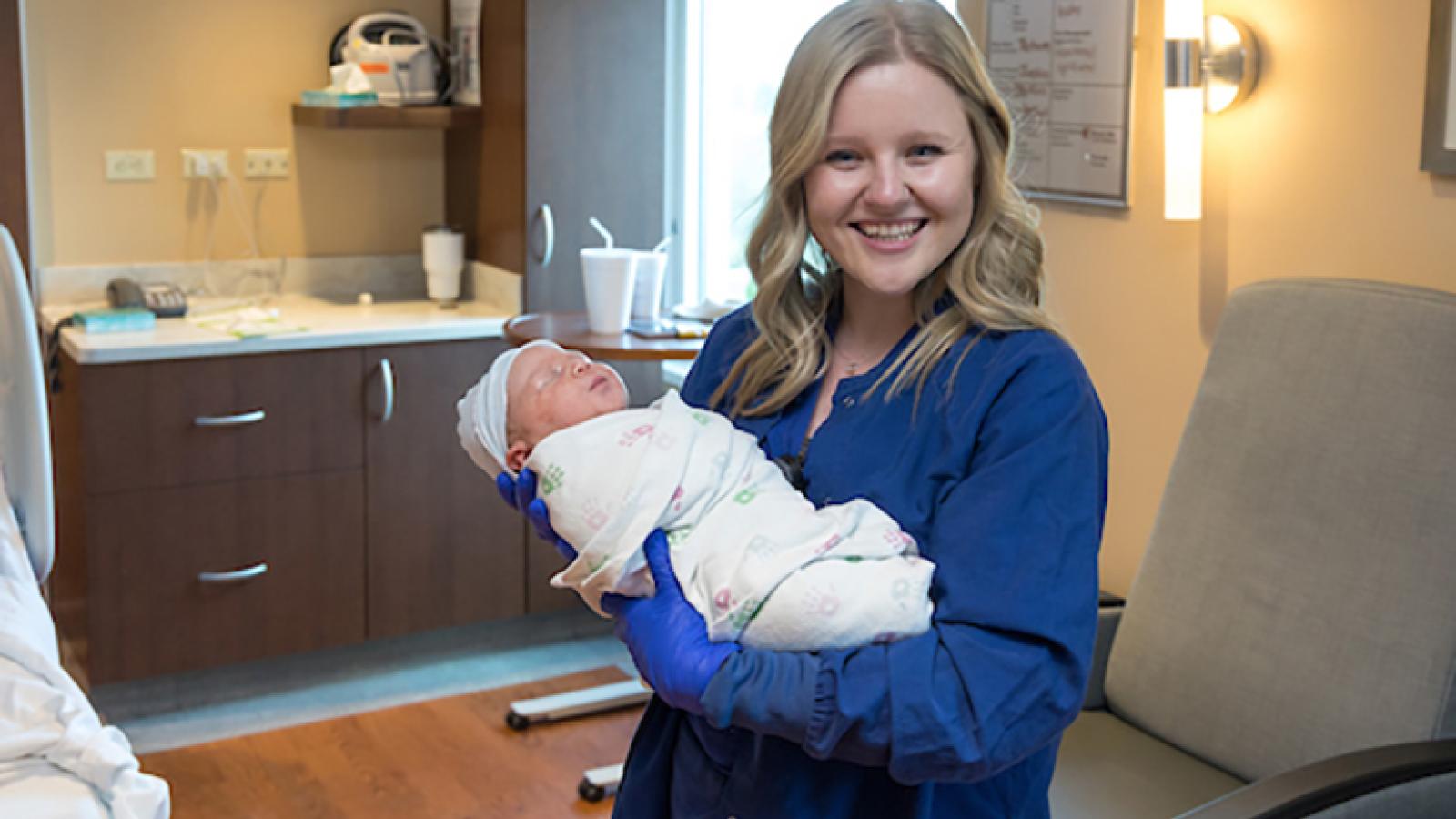 Nurse holds newborn