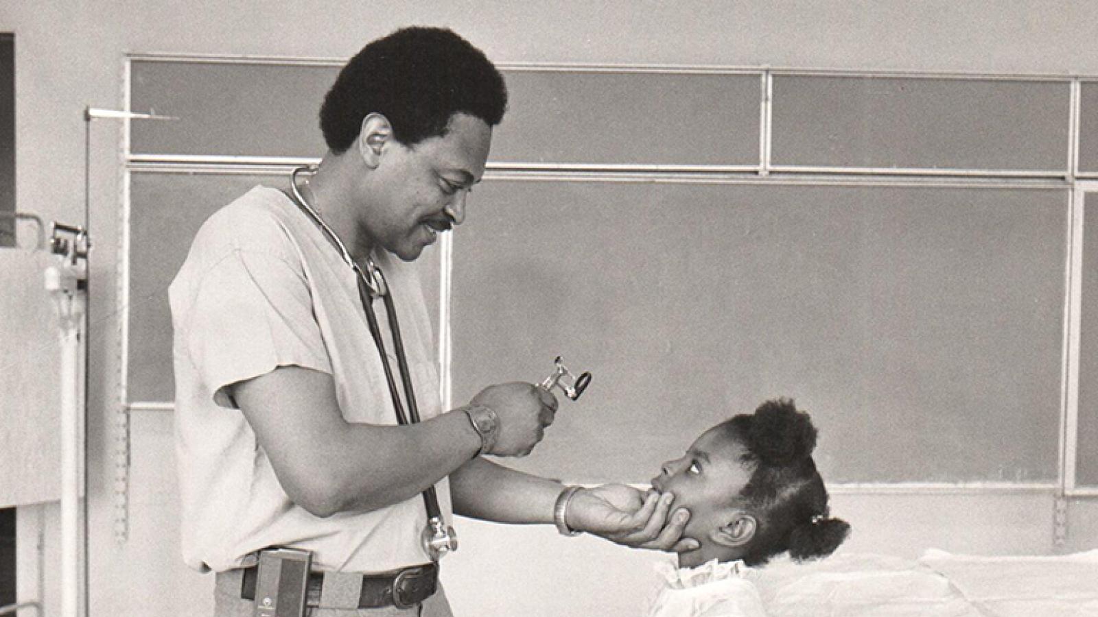 Robert Jordan, MD, giving a girl a check-up