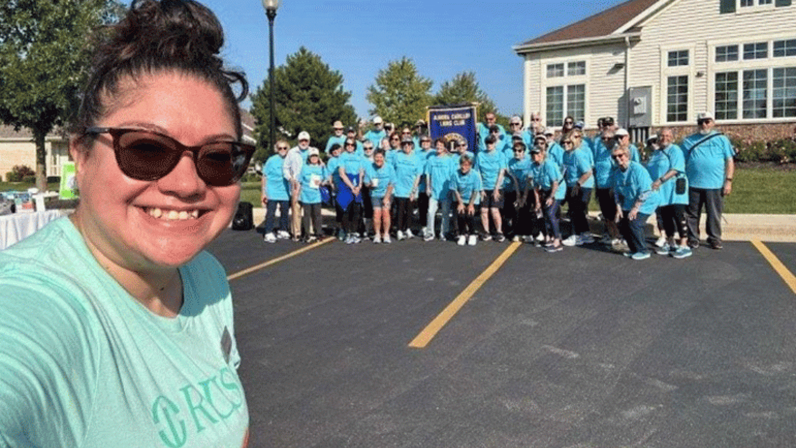 A rep from Waterford Place takes a selfie with the walkers from the Aurora Carillon Lions Club during their walkathon. 