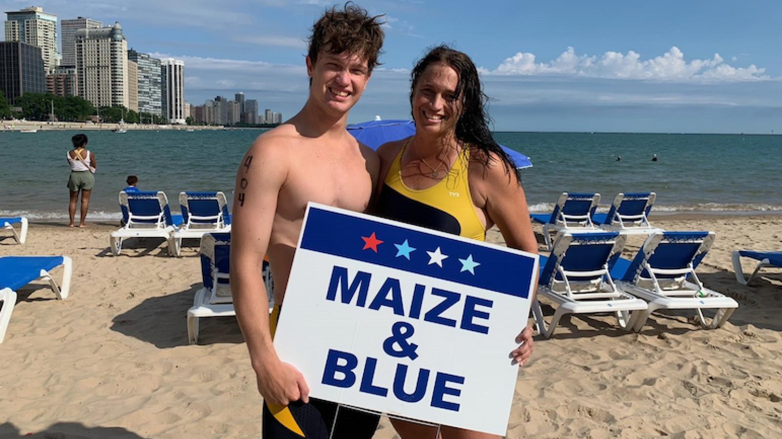 Katrina Martin and her son Rob participate in the 2023 Swim Across America – Chicago Open Water Swim, honoring her late husband, Dana, with their team sign.