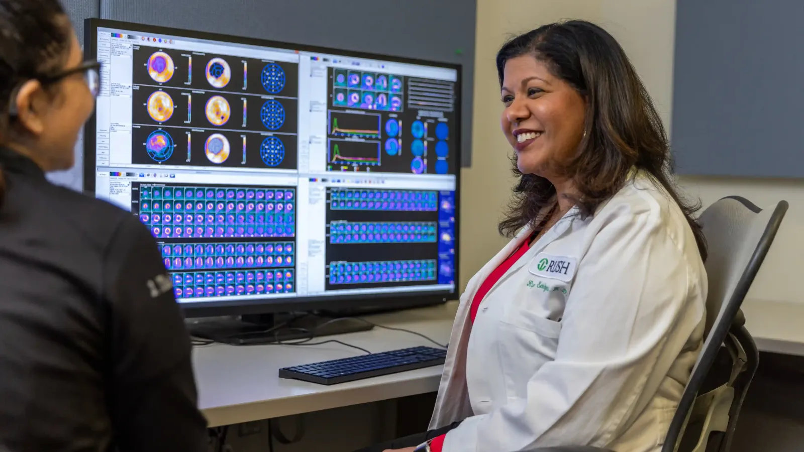 Cardiologist Rupa Sanghani, MD looking at and discussing heart lab imagery.