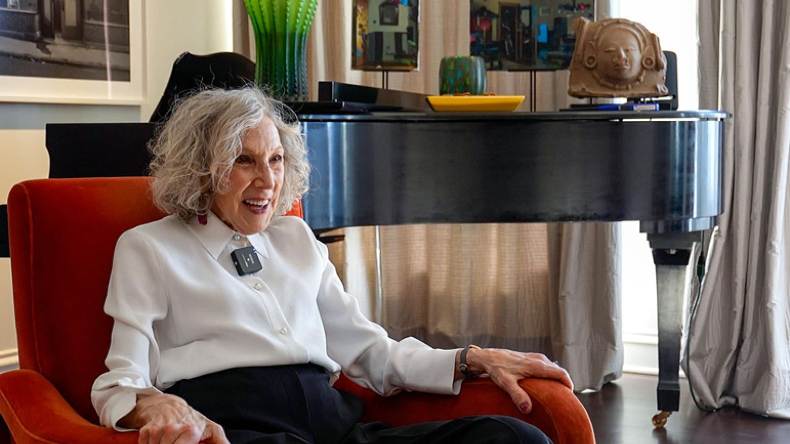 Sherry Koppel sits on a red chair