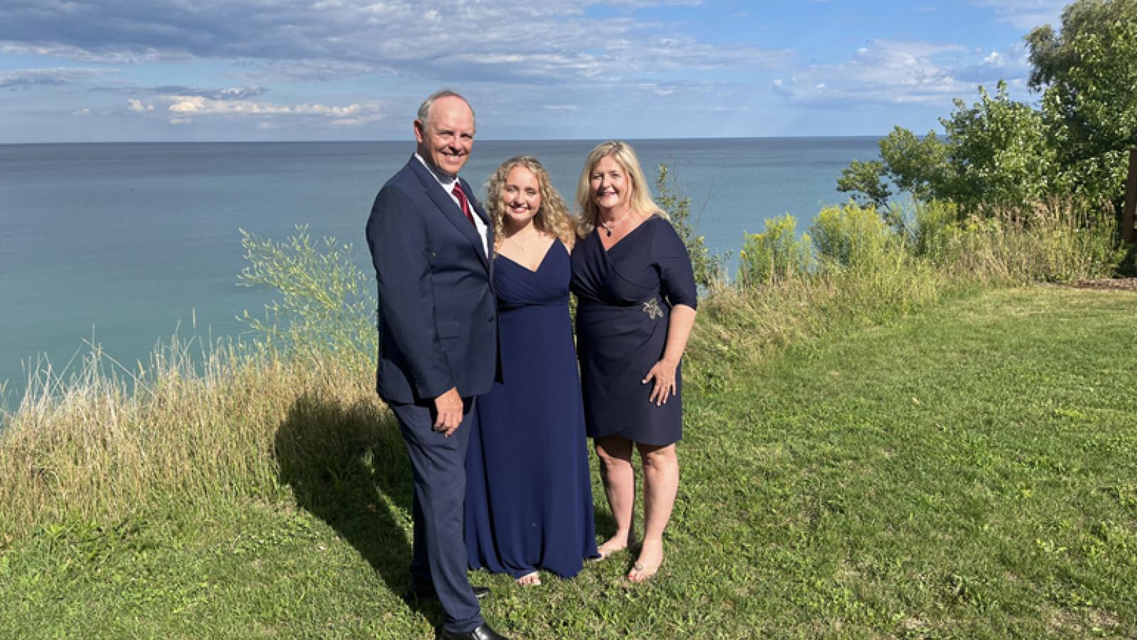 Steve Stark (left) smiles with his daughter and wife.