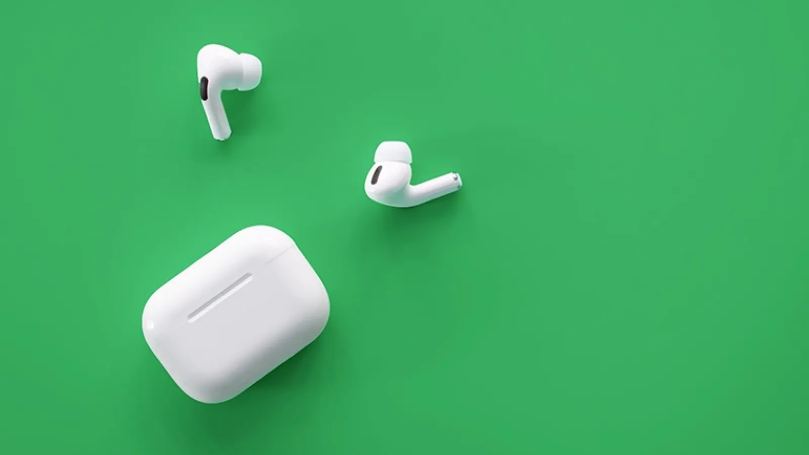 AirPods on green background