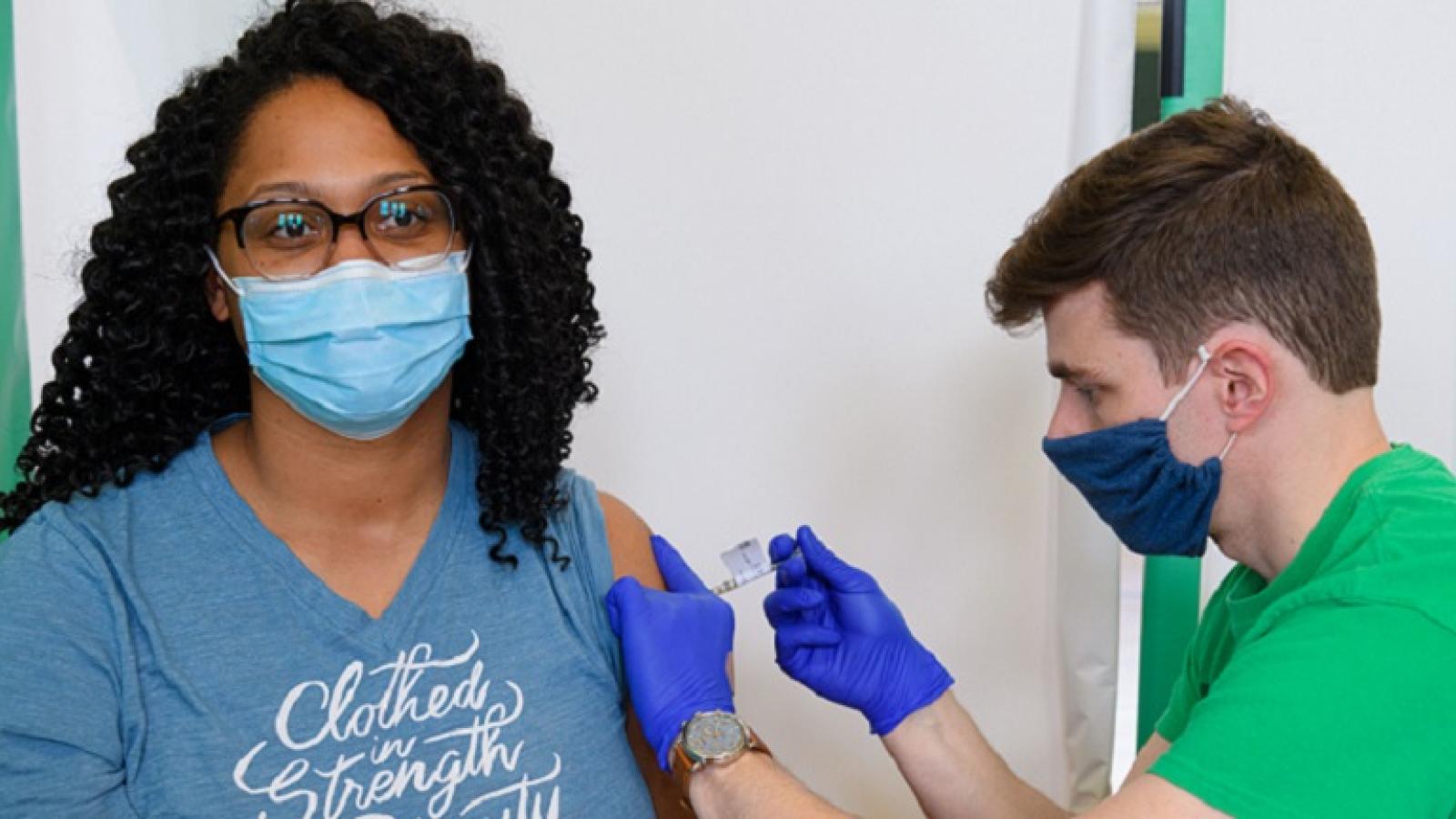 A woman receives the COVID-19 vaccine