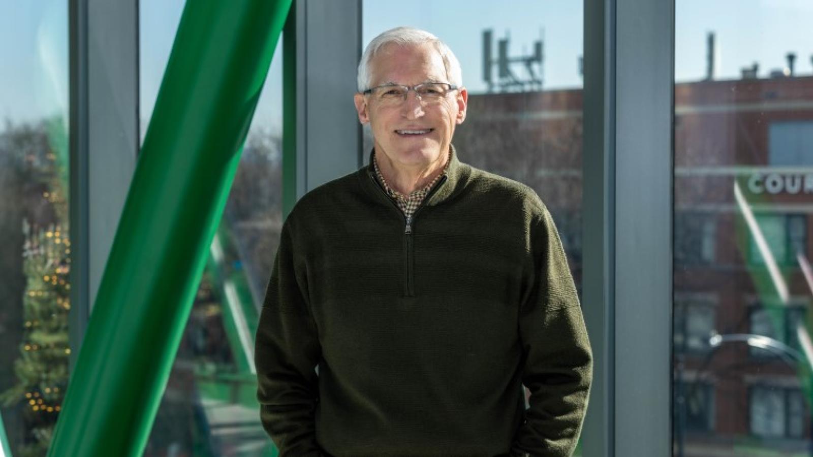 Patient Bob Costigan stands in the skyway over Ashland Avenue leading to the Rubschlager Building.