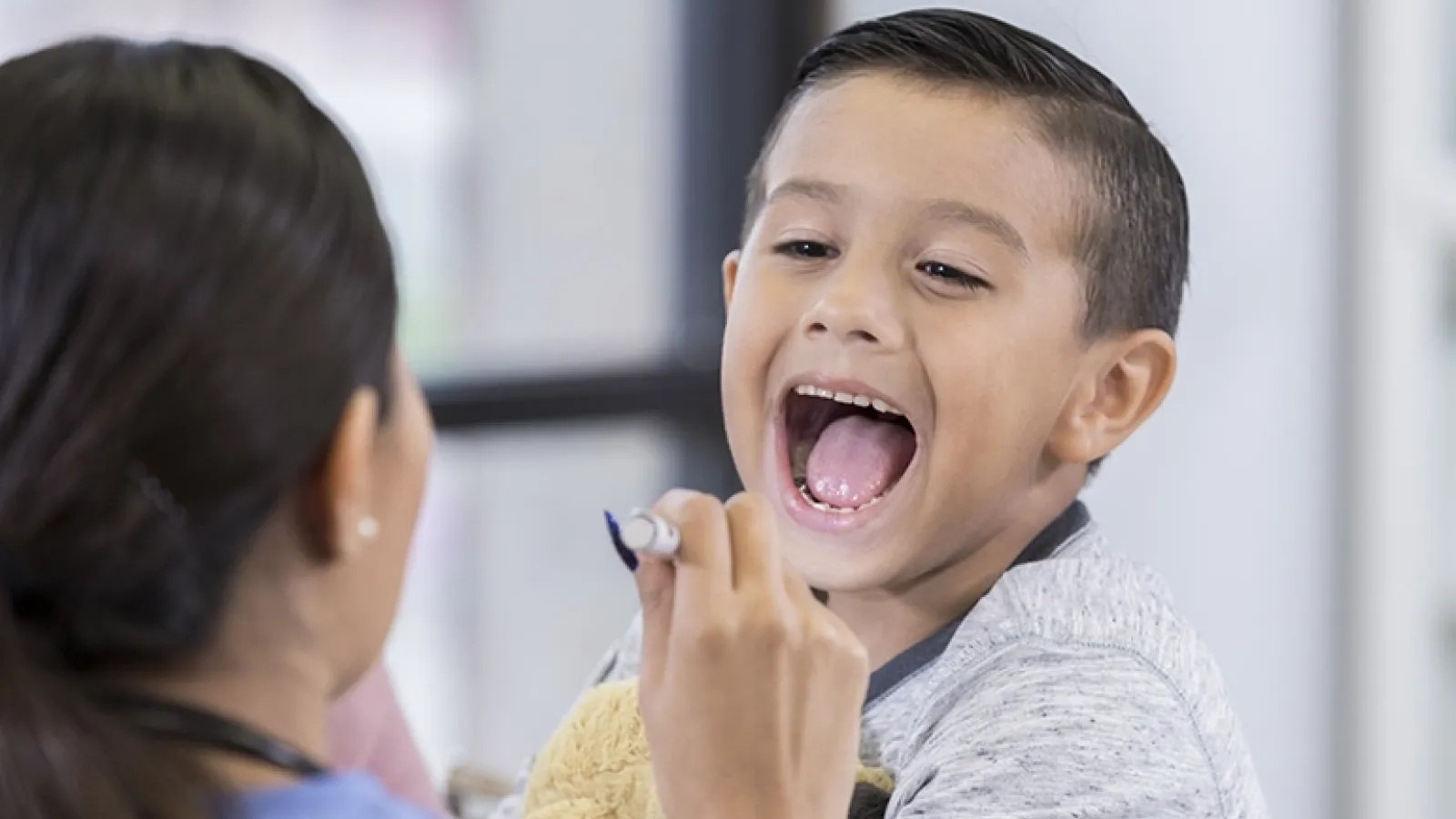 Boy saying 'aaah' at doctor's office