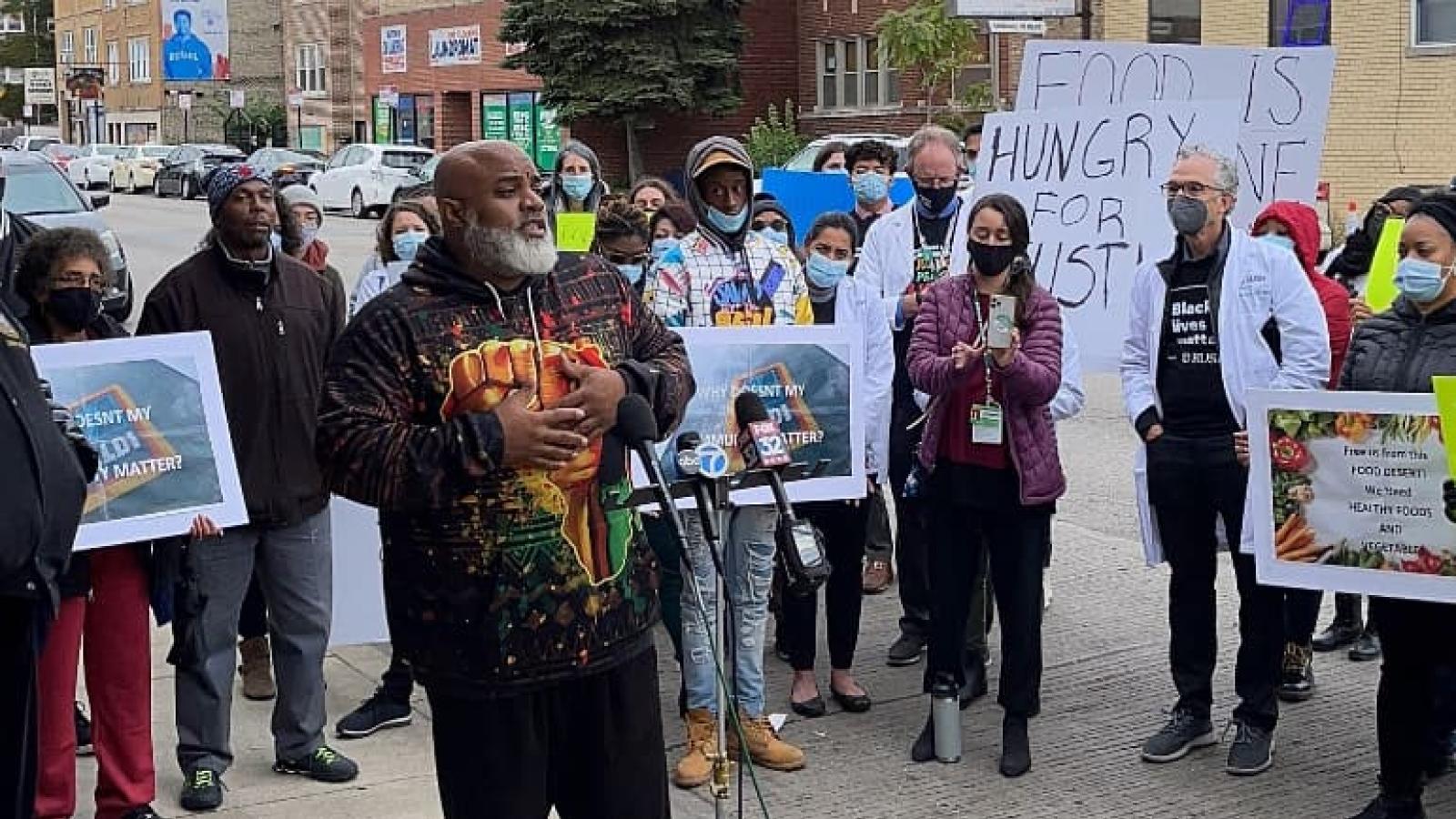 Community leaders speak to the media about food insecurity on Chicago's West Side