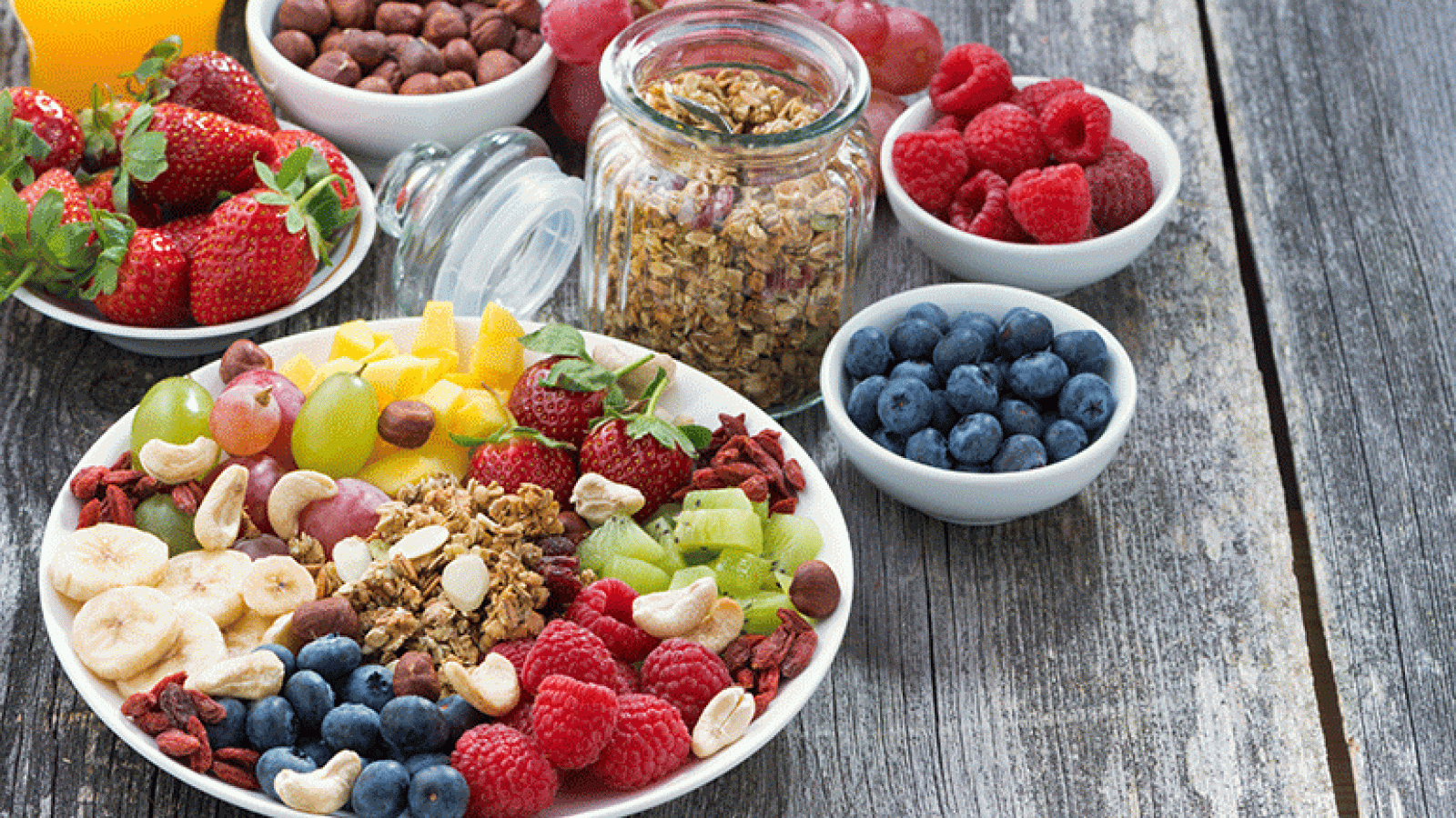 Bowls of fruits and grains on table