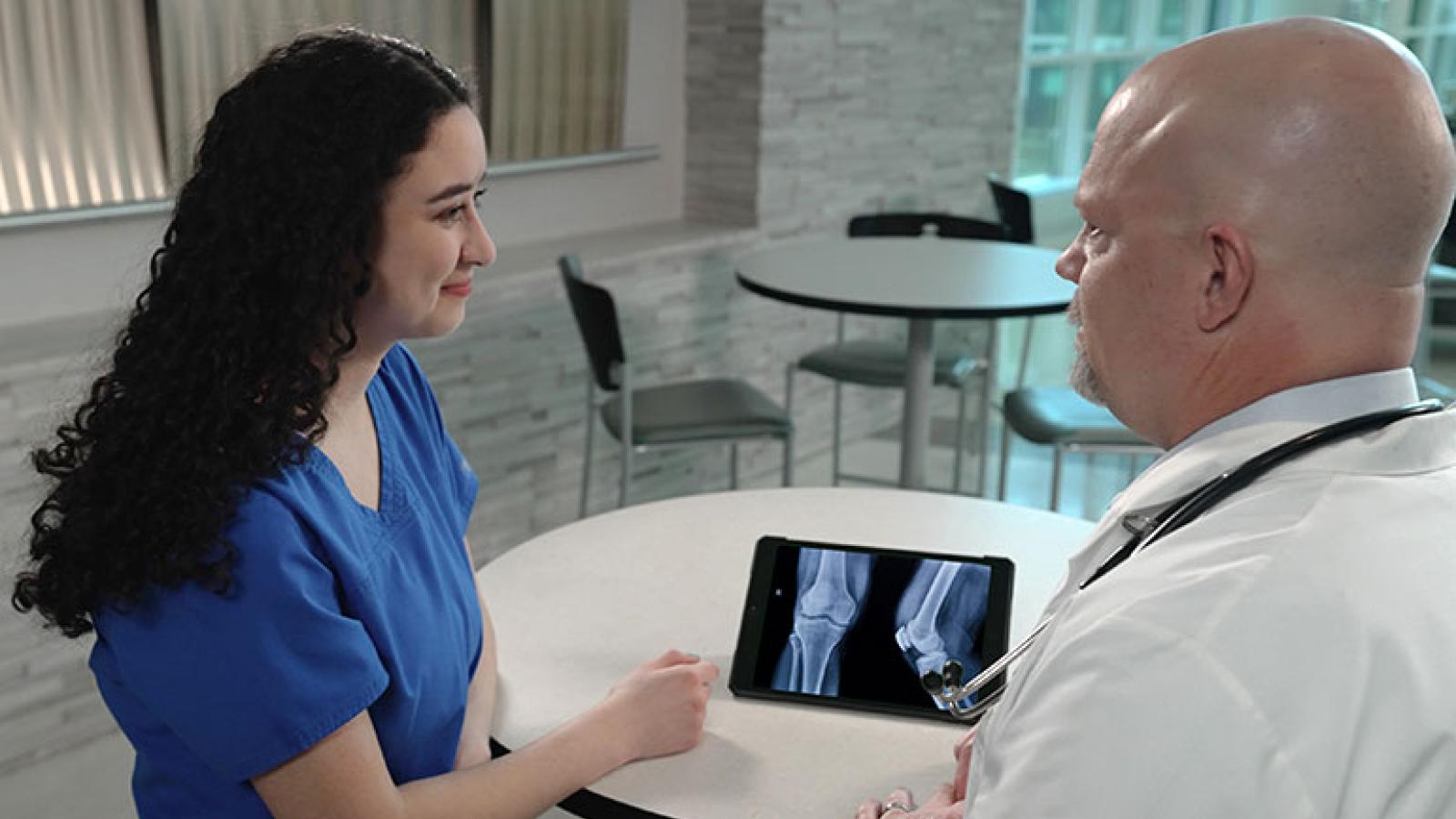 Garrett Katula, DO, with student