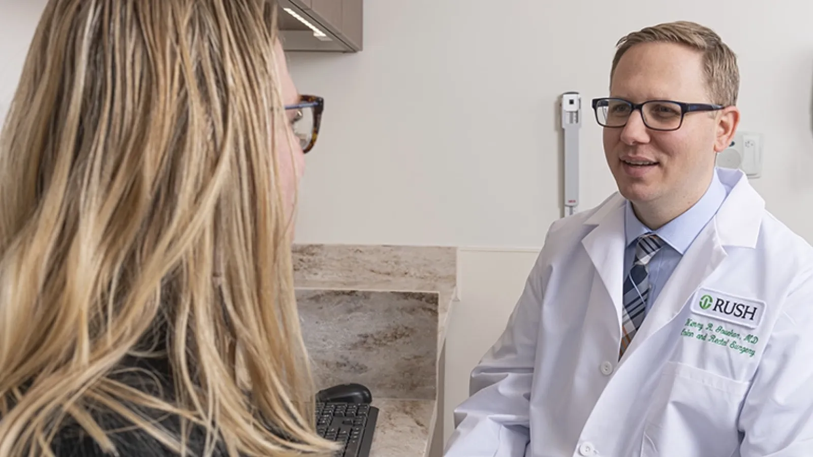 Henry Govekar, MD, talks to a patient