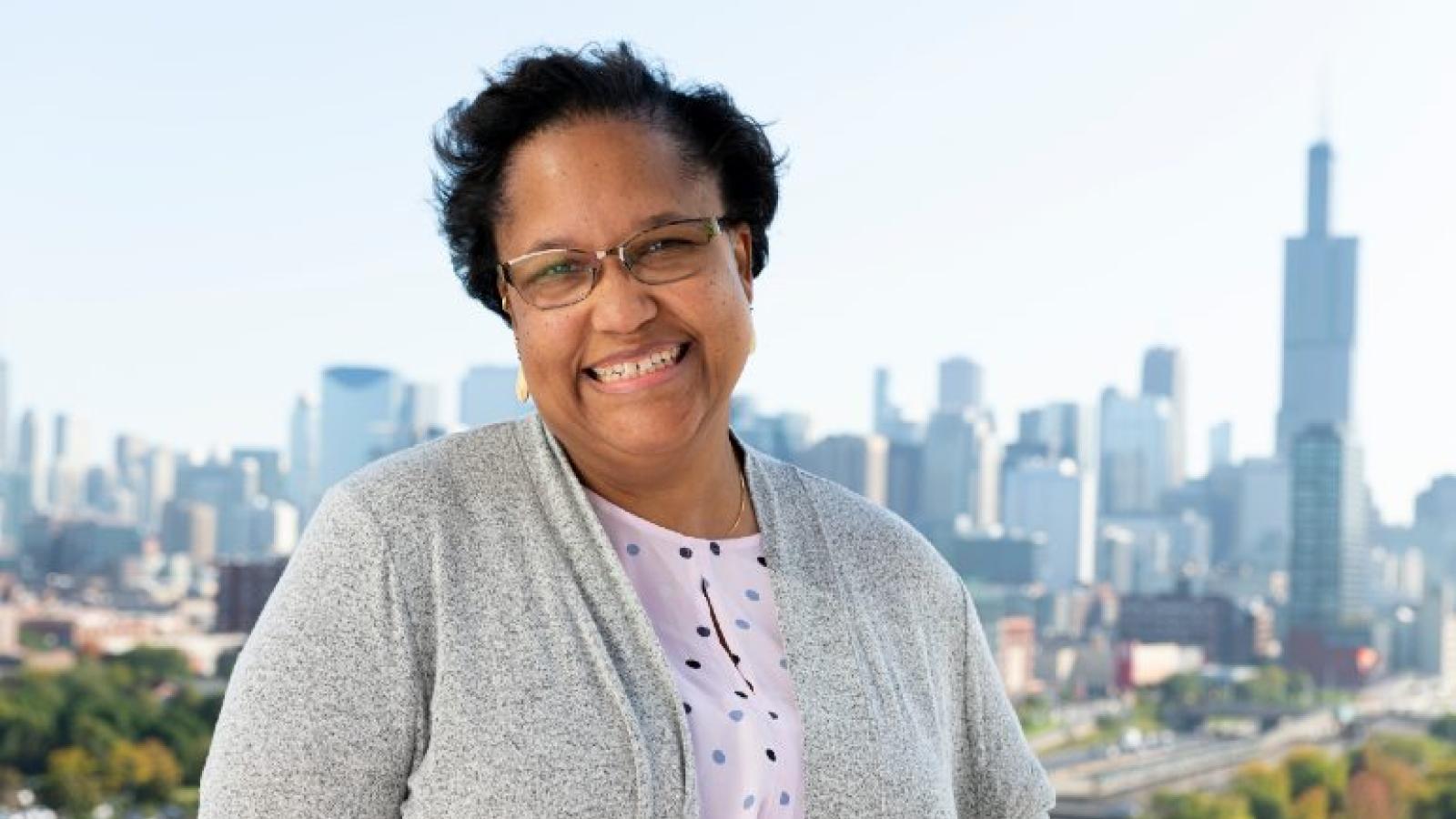 Smiling woman with Chicago skyline in background