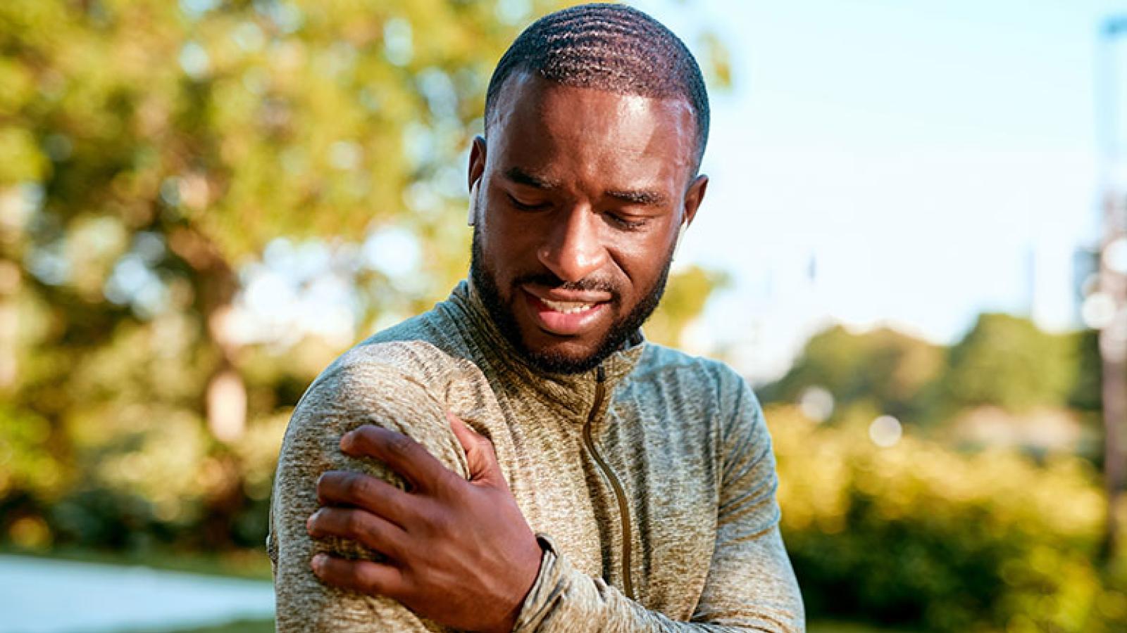 Man clutching shoulder