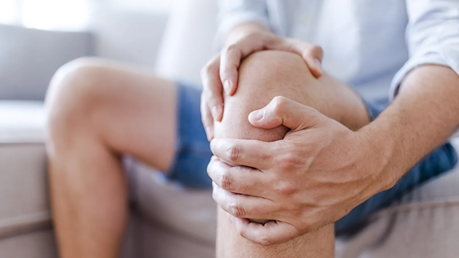 Man holding his knee